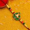 Green Tulsi Leaf Rakhi With Orange Enamel Flower And Beaded Thread