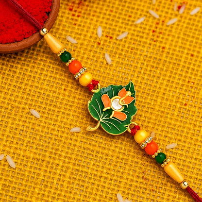 Green Tulsi Leaf Rakhi With Orange Enamel Flower And Beaded Thread